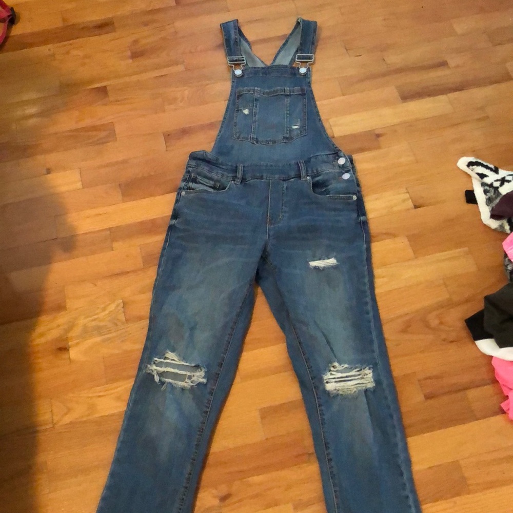 Blue overalls with cutouts.